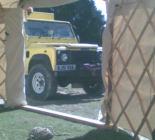 Defender expedition vehicle in yurt door